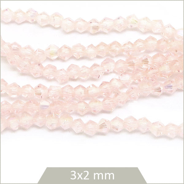 Env. 135 perles de verre toupies nude irisé, 3x2 mm