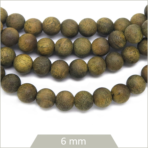 Env. 64 perles rondes en bois de santal, 6 mm