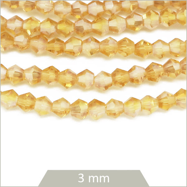 Env. 135 perles de verre toupies or nude irisé, 3 mm