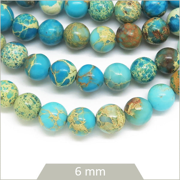 Env. 60 perles rondes Régalite teintée bleu ciel 6 mm