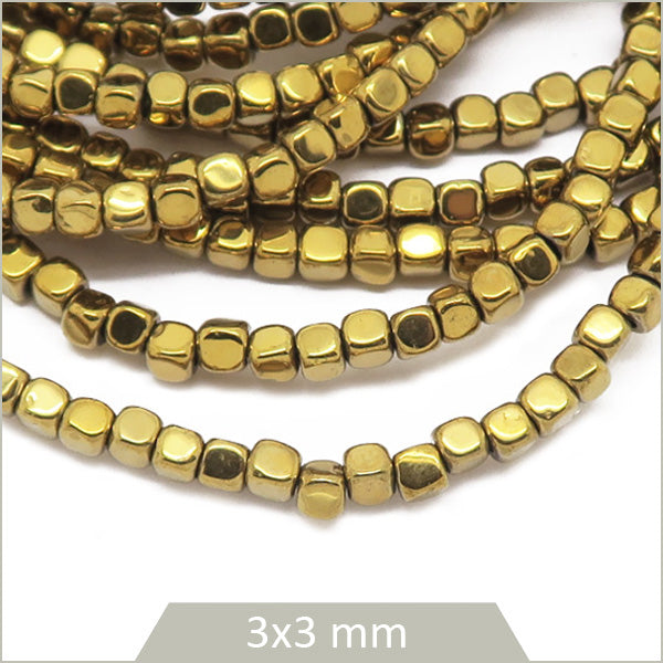 Env. 135 perles cubes arrondis 3 mm en hématite doré clair